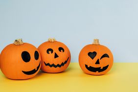 Three painted pumpkins on a yellow and blue background