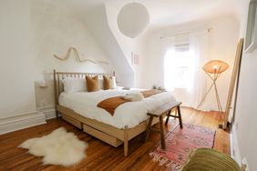 Alexandra Gater Bedroom Makeover, light neutral color bedding with wooden bed frame