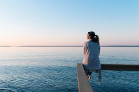 Mental Health Benefits of Being Near Water: woman gazing out at the water
