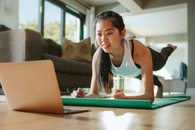 Better screen time: Woman watching sport training online on tablet