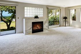 Beautitful living room carpet with fireplace and walkout deck