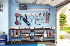 neatly organized sports equipment on garage wall