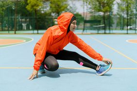 Different Types of Exercise Intensity: woman runner stretching outdoors