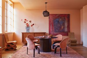 Terracotta-colored living room with dining set and buffet. 