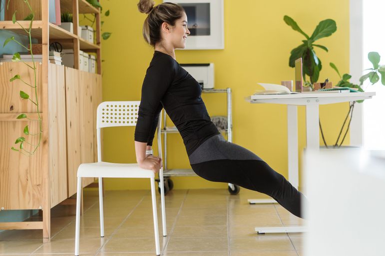 woman exercising on office chair