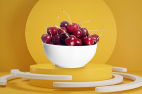 Foods That Help You Sleep: bowl of cherries on a pedestal