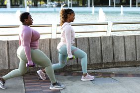 Full Body Workout: Two women doing lunge exercises together in a city park