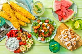 Summer bbq party concept - grilled chicken, vegetables, corn, salad, top view