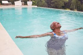 What Does Longevity Mean? How to Live a Longer, Happier, Healthier Life: A mature woman relaxes in a swimming pool o a rainy day