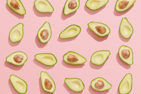 Avocados on pink background