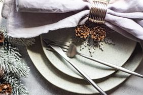 Holiday Cleaning Plan, holiday table place setting with pine cones