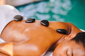hot-stone-massage-GettyImages-1372664129