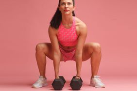 woman with dumbbells doing isometric exercises
