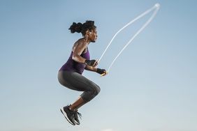 woman jumping rope in sky