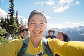 Multi-Ethnic Family Smiling for Selfie on Alpine Mountain Hike