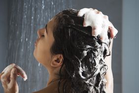 Person taking a shower and washing their hair