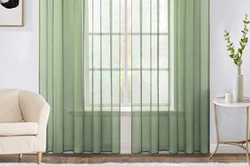 Room with airy green sheer curtains on window