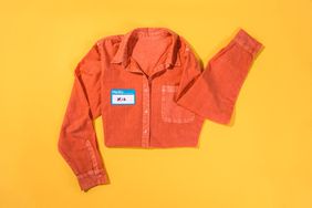 Overhead view of an orange shirt with a name tag on a yellow background