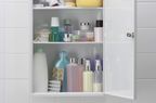 Bathroom medicine cabinet with toiletries in bottles 