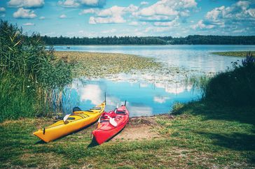 Toe dip trips travel idea post-pandemic: kayaks next to a lake