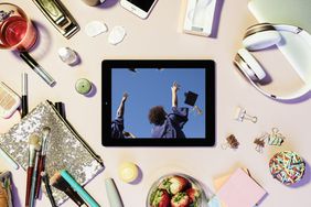 Tips for Navigating the Shift From College Student to Working Adult: tablet with image of graduation ceremony