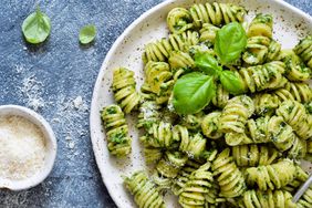 Fusilli with green pesto sauce on a plate