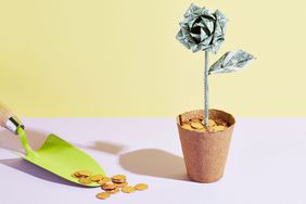 A gardeners trowel sits next to an origami dollar flower