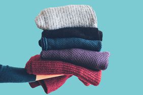 How to Care for Winter Clothes: stack of folded sweaters and scarves