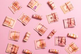 Directly Above Shot Of Banknotes Over Pink Background
